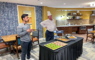 Dietician and chef with table of healthy snacks